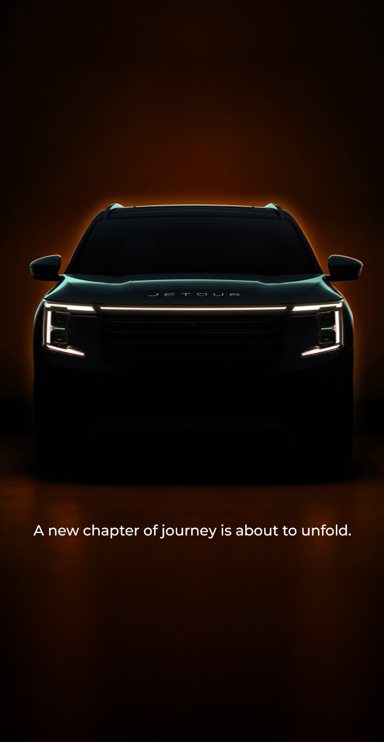 Front view of a JETOUR SUV with illuminated headlights against an orange glow. A new chapter of journey is about to unfold.